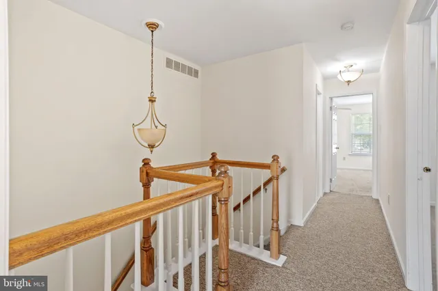 a view of a hallway with stairs
