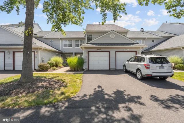 a car parked in front of white house