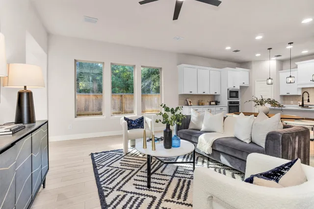 a living room with furniture and a large window