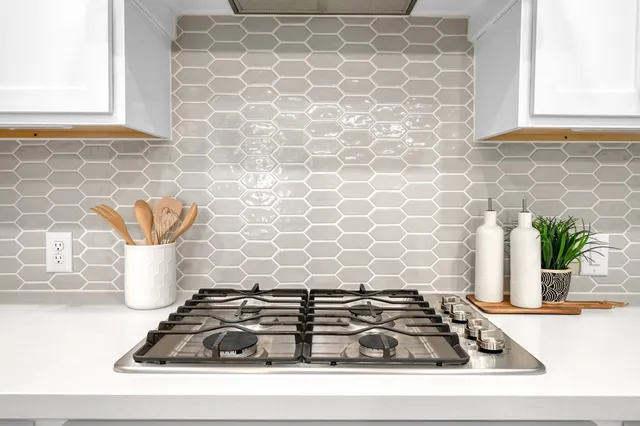 a kitchen with a sink and a white wooden cabinets