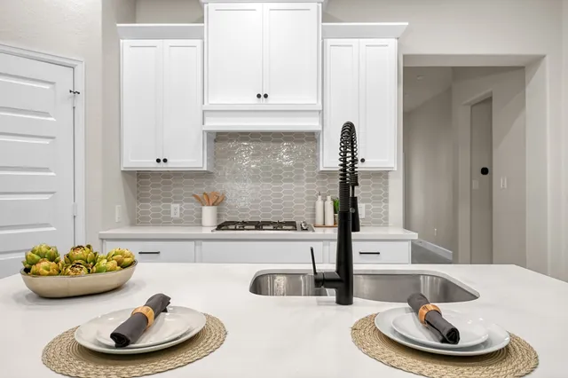 a kitchen with a sink and a stove
