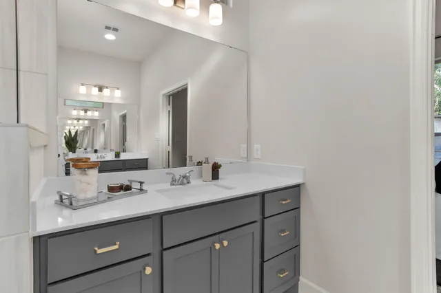 a work room with furniture a rug and white walls