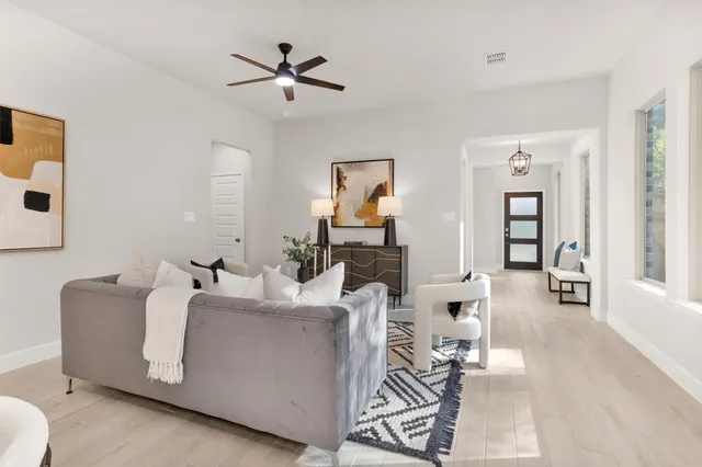 a living room with furniture and wooden floor