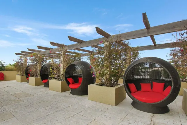 a view of a swimming pool with furniture