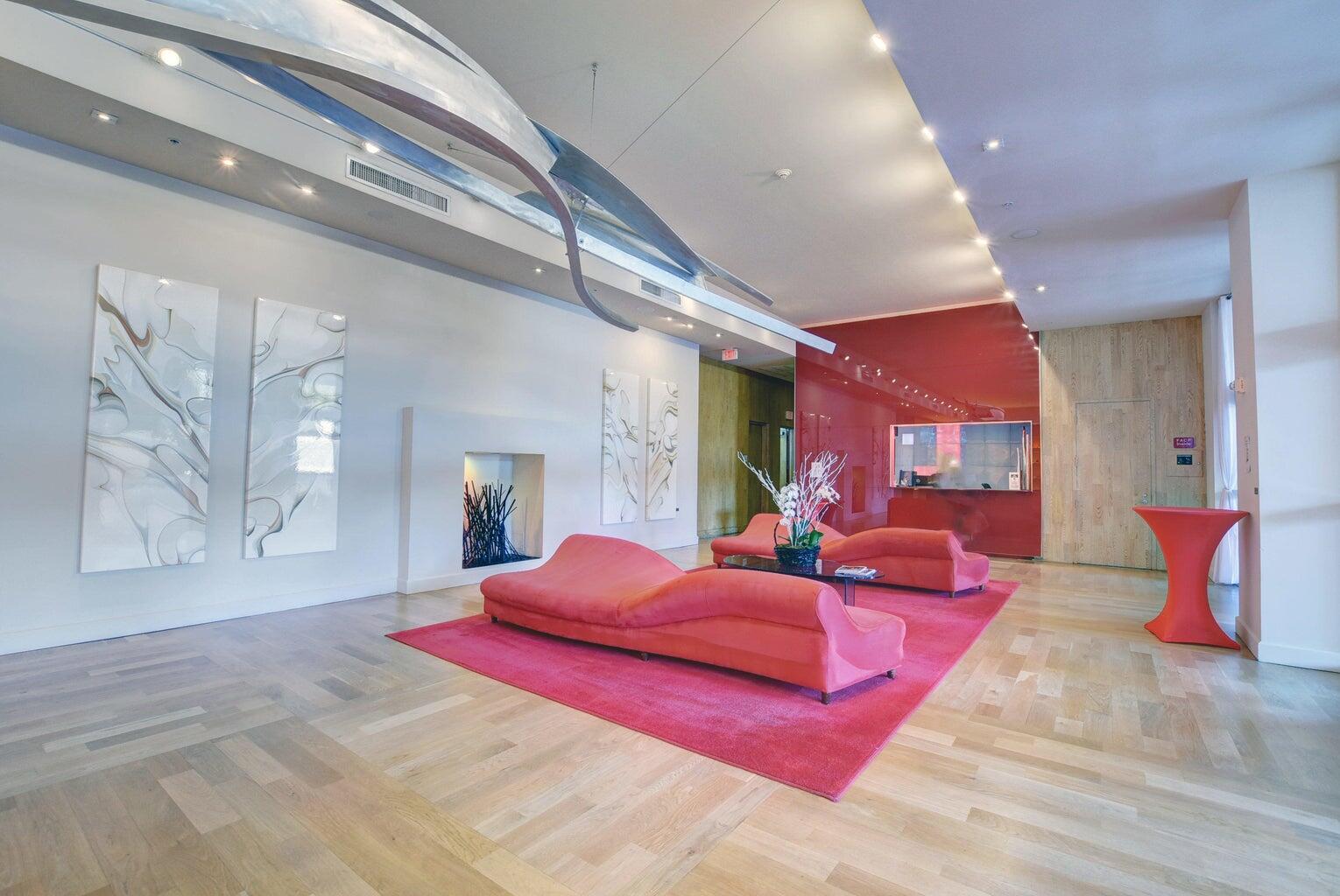 1551 North Flagler Drive, Unit 802 West Palm Beach, FL 33401 - Photo 28 of 31 a living room with furniture and a chandelier