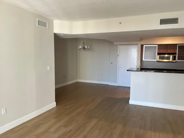 a view of a kitchen with wooden floor and a sink