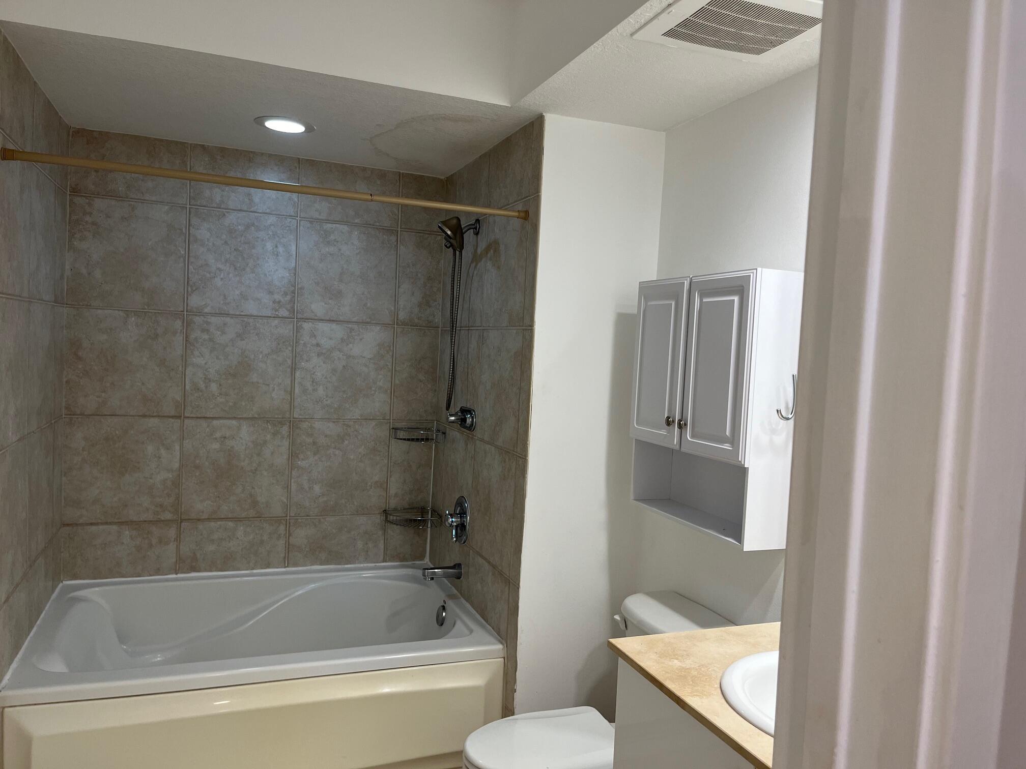 1551 North Flagler Drive, Unit 802 West Palm Beach, FL 33401 - Photo 9 of 31 a white bath tub sitting next to a toilet