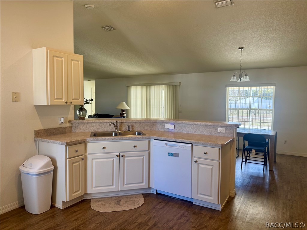 4588 East Van Ness Road Inverness, FL 34453 - Photo 3 of 34 a kitchen with a sink and wooden floor