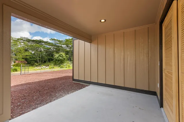 a view of a room with a large window and tree