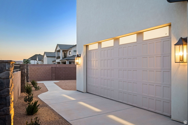 4871 South Homestead Way Washington, UT 84780 - Photo 113 of 151 Garage at dusk with concrete driveway