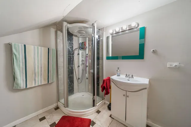 a bathroom with a sink toilet and shower