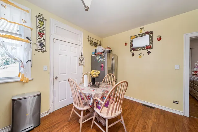 a view of a dining room with furniture wooden floor and front door