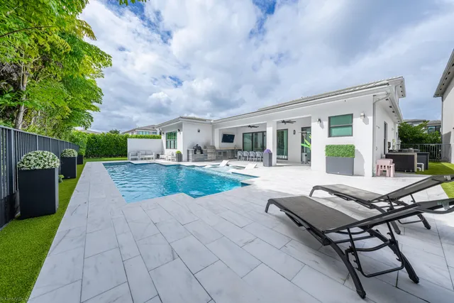 a view of a dining room and livingroom with furniture wooden floor and a rug