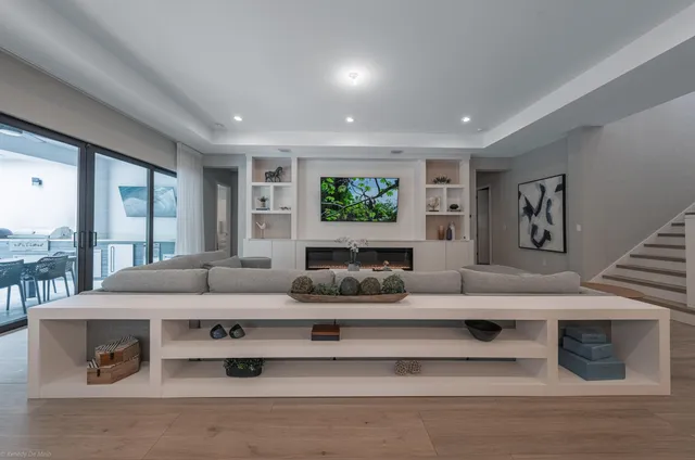 a spacious bedroom with a bed window and a chandelier