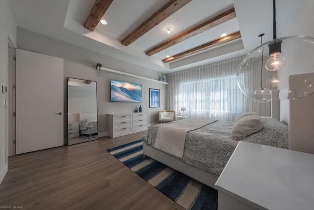 a bedroom with a bed and a potted plant