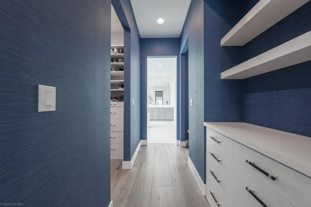 a bedroom with a large bed and a wooden floor