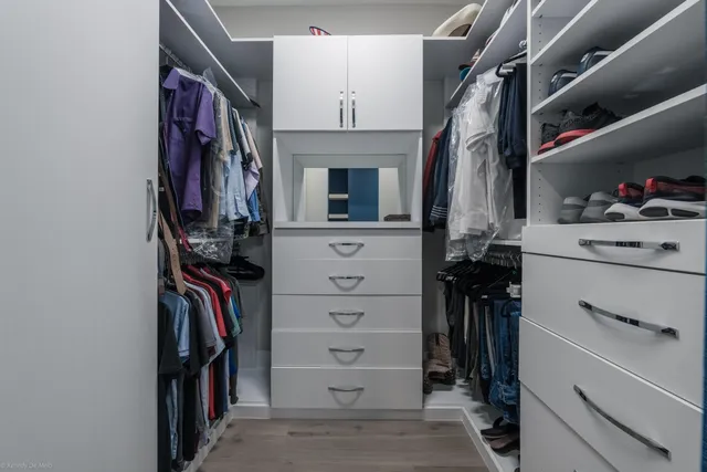a bathroom with a shower sink vanity mirror and toilet