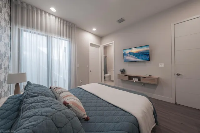 a living room with furniture and a view of kitchen