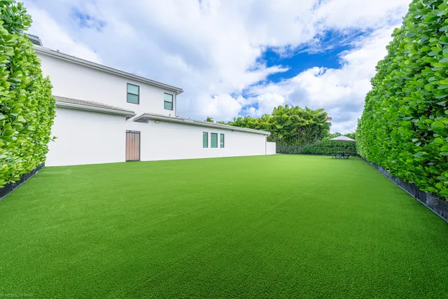 a kitchen with stainless steel appliances kitchen island granite countertop wooden floors and view living room