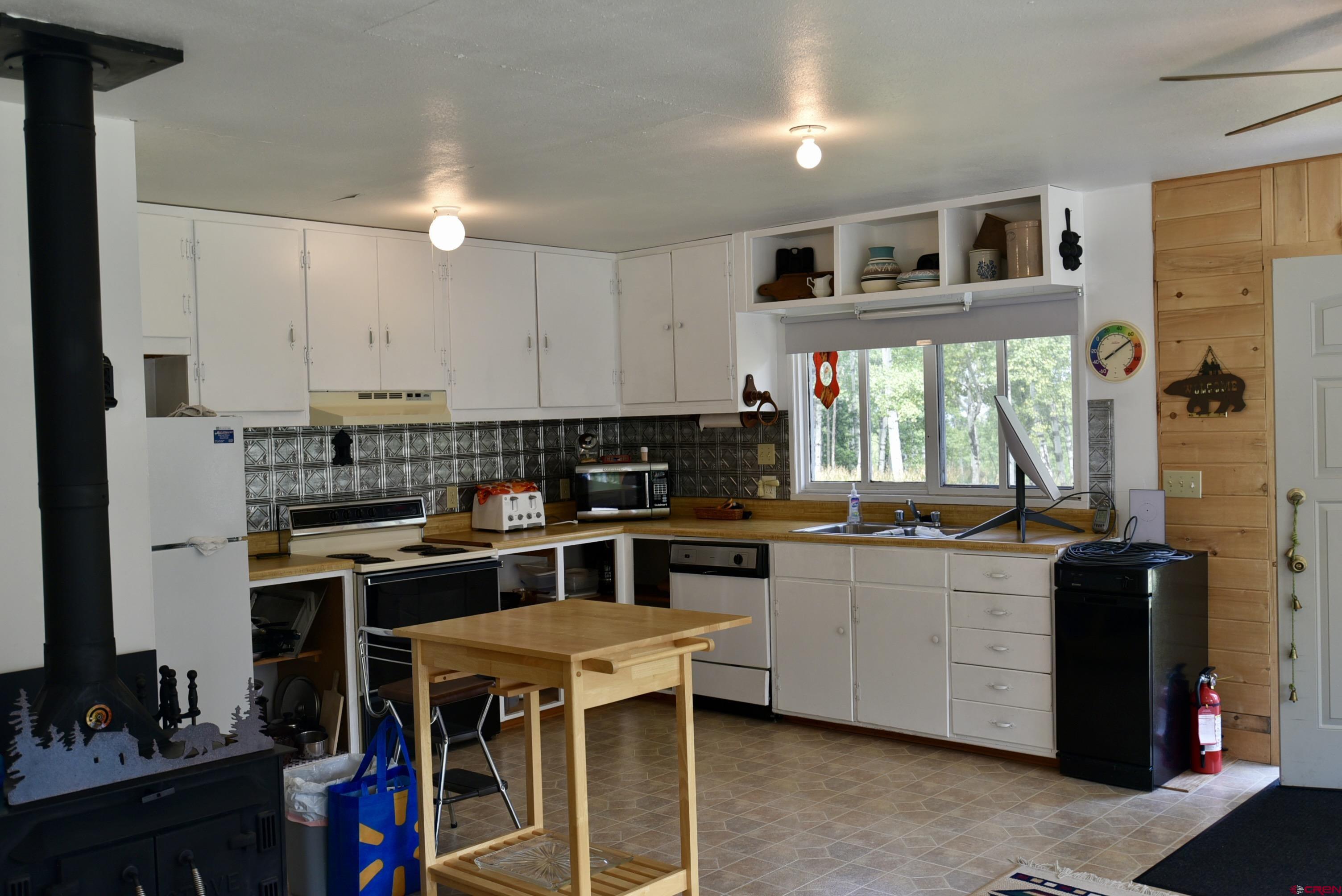 704 Hampton Road Montrose, CO 81220 - Photo 5 of 45 a kitchen with stainless steel appliances a stove a sink a refrigerator and cabinets