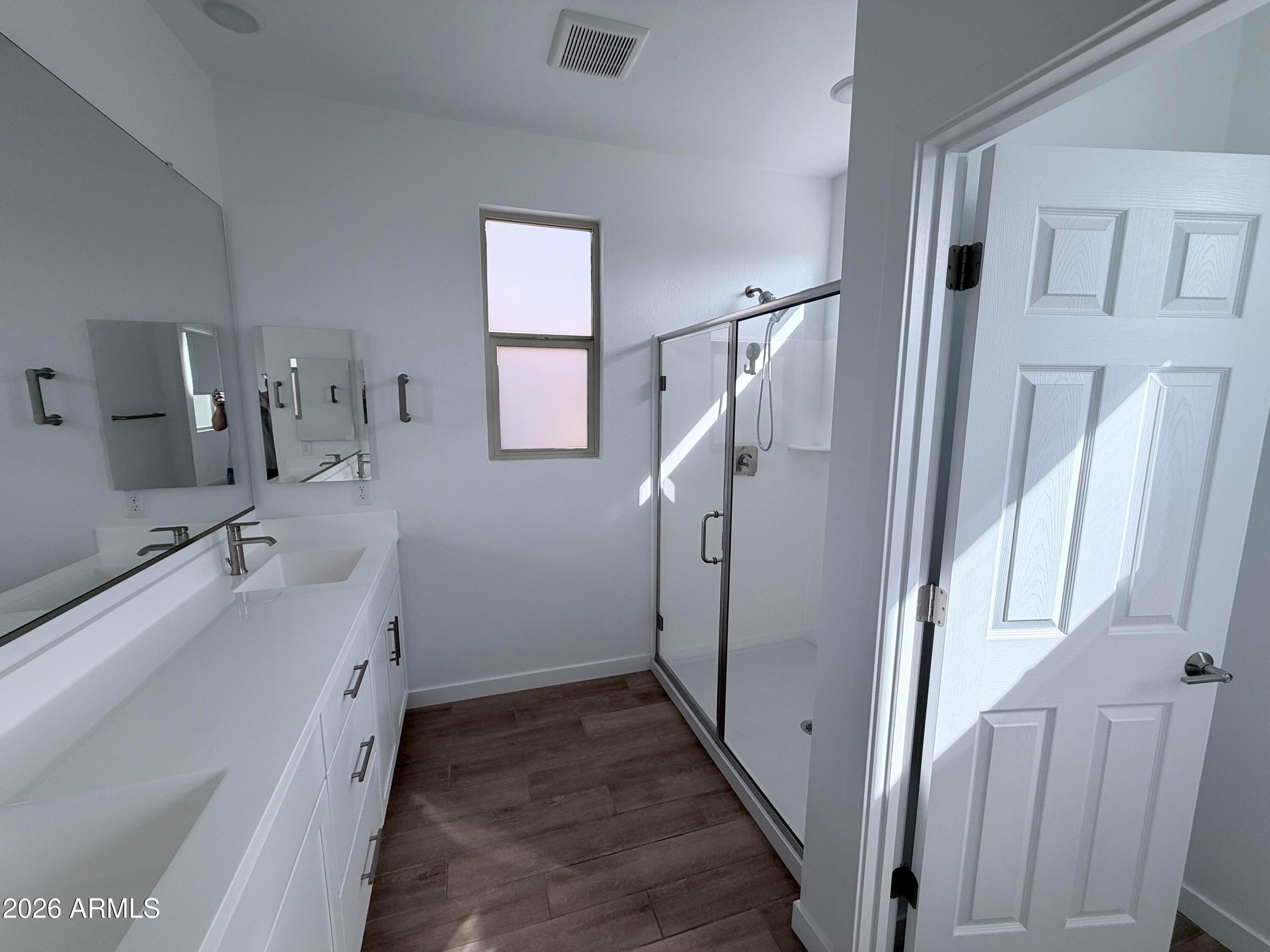 4323 West Palace Sta Road New River, AZ 85087 - Photo 13 of 20 a bathroom with a double vanity sink and mirror