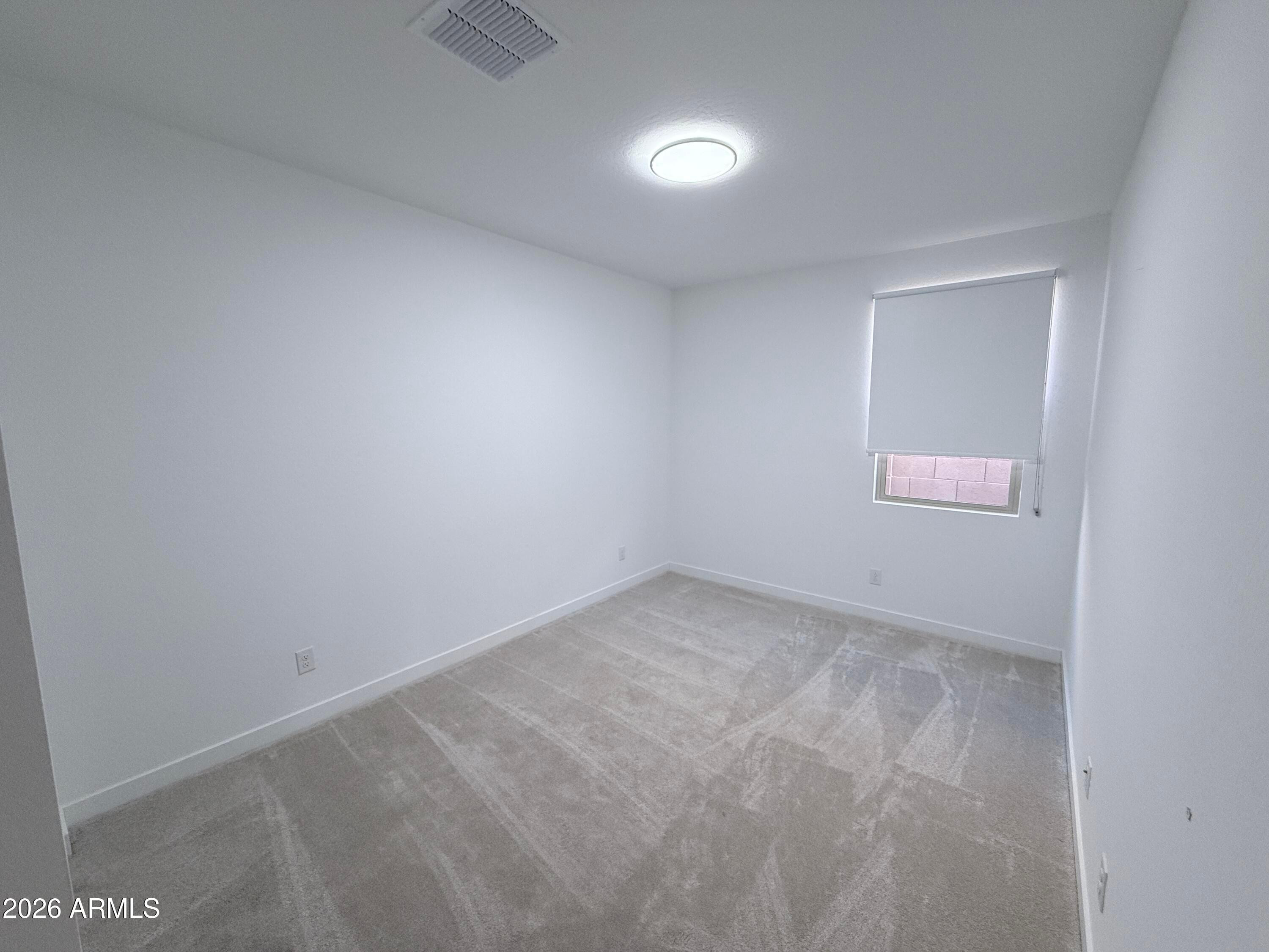 4323 West Palace Sta Road New River, AZ 85087 - Photo 16 of 20 an empty room with a window
