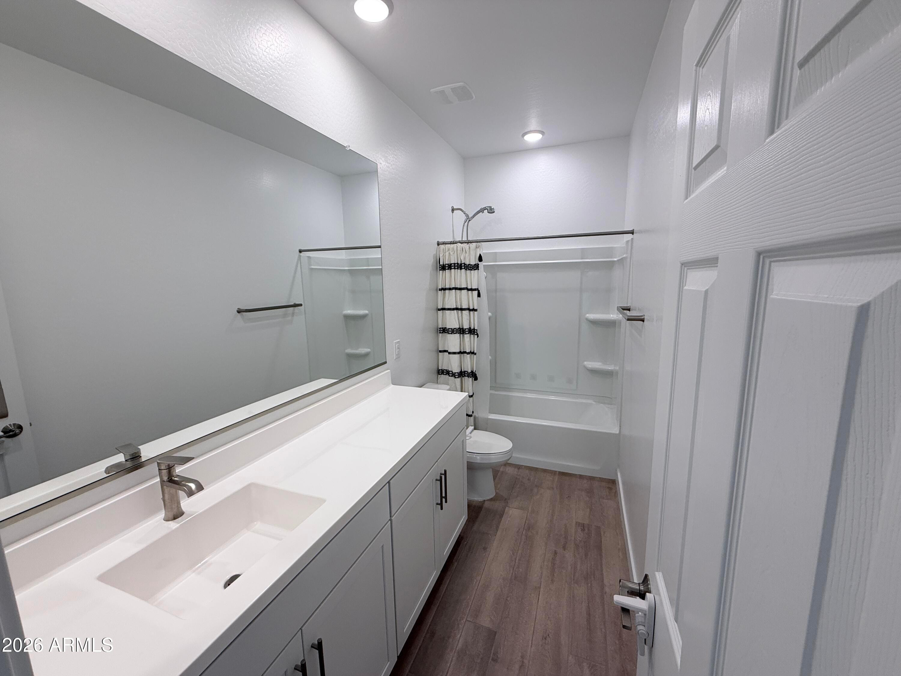 4323 West Palace Sta Road New River, AZ 85087 - Photo 17 of 20 a bathroom with a double vanity sink a toilet and shower