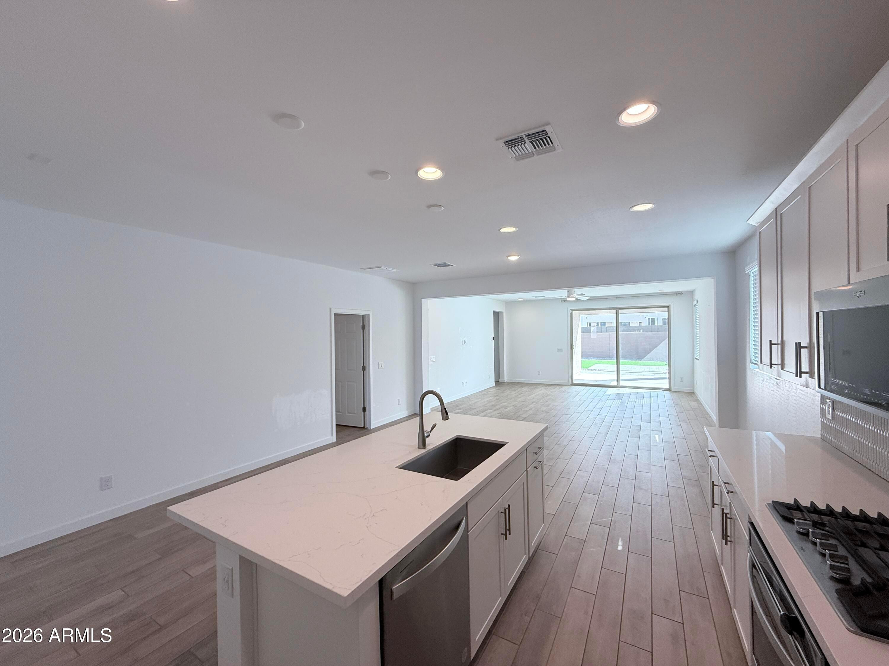 4323 West Palace Sta Road New River, AZ 85087 - Photo 7 of 20 a kitchen that has a sink and a stove in it