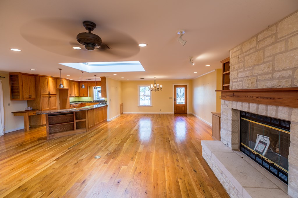 307 Frederick Road Fredericksburg, TX 78624 - Photo 3 of 14 a view of a living room a fireplace with wooden floor