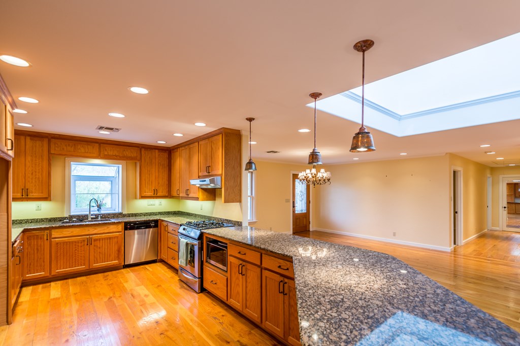 307 Frederick Road Fredericksburg, TX 78624 - Photo 5 of 14 a large kitchen with stainless steel appliances kitchen island granite countertop a sink and cabinets