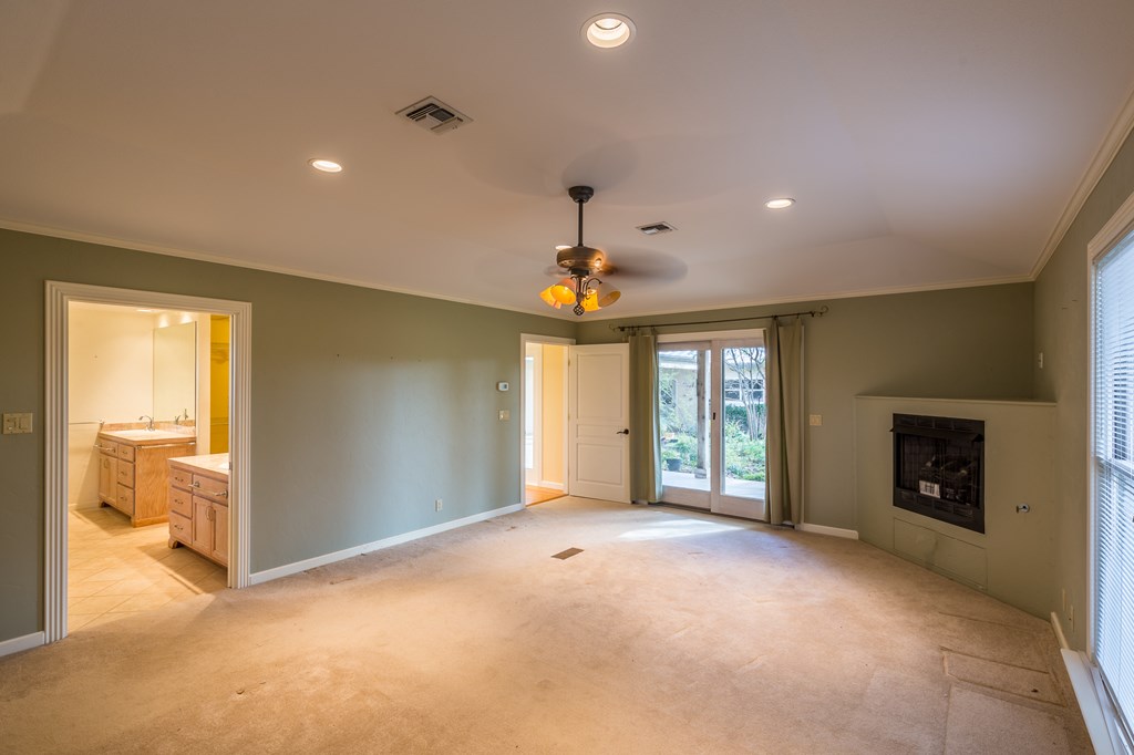 307 Frederick Road Fredericksburg, TX 78624 - Photo 7 of 14 a view of an empty room with a fireplace and a window