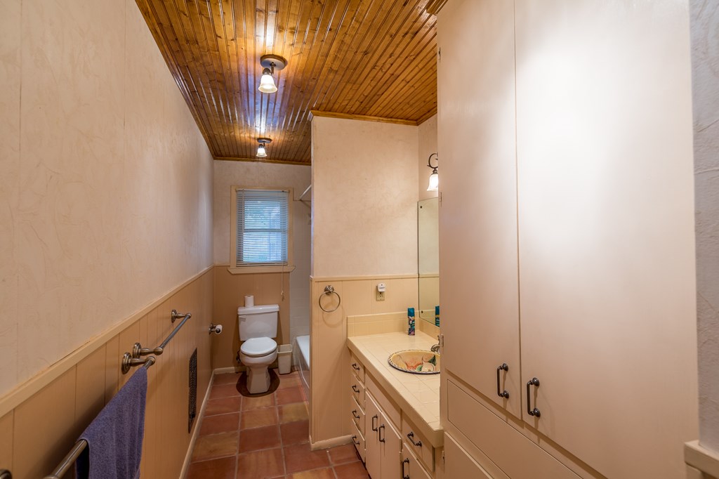 307 Frederick Road Fredericksburg, TX 78624 - Photo 10 of 14 a bathroom with a sink and mirror with bathtub