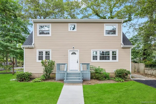 a front view of house with yard and green space