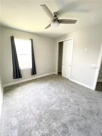 a view of an empty room and a window