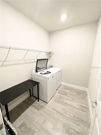 a view of storage and utility room with washer and dryer