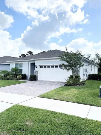 a view of a house with a yard and a garden