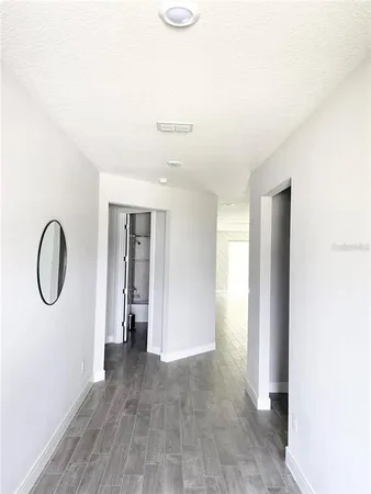 a view of room with window and wooden floor
