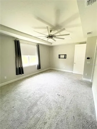 an empty room with a empty space and windows