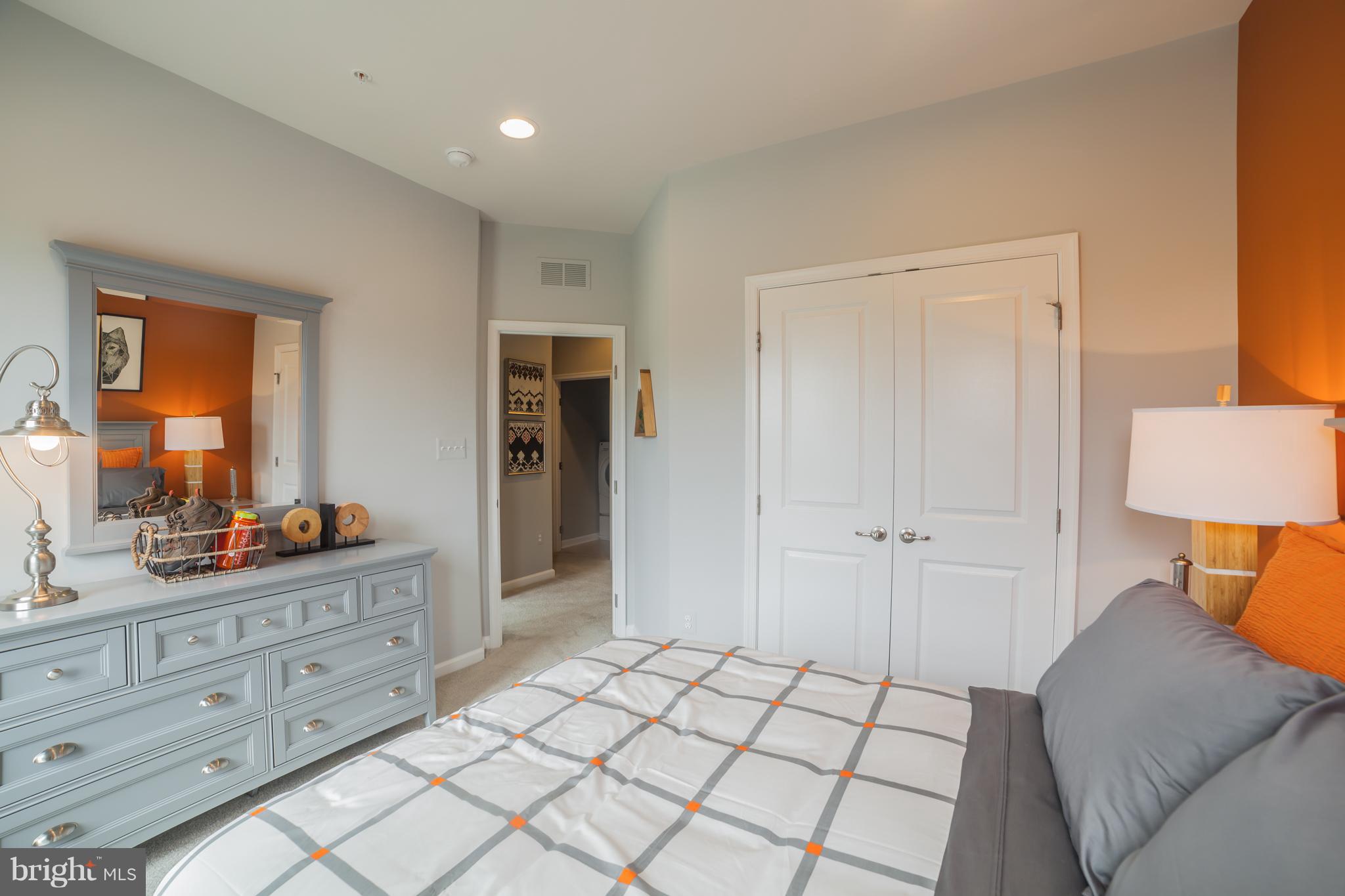 8283 Kippis Road Millersville, MD 21108 - Photo 13 of 28 a spacious bedroom with a bed and a dresser in it