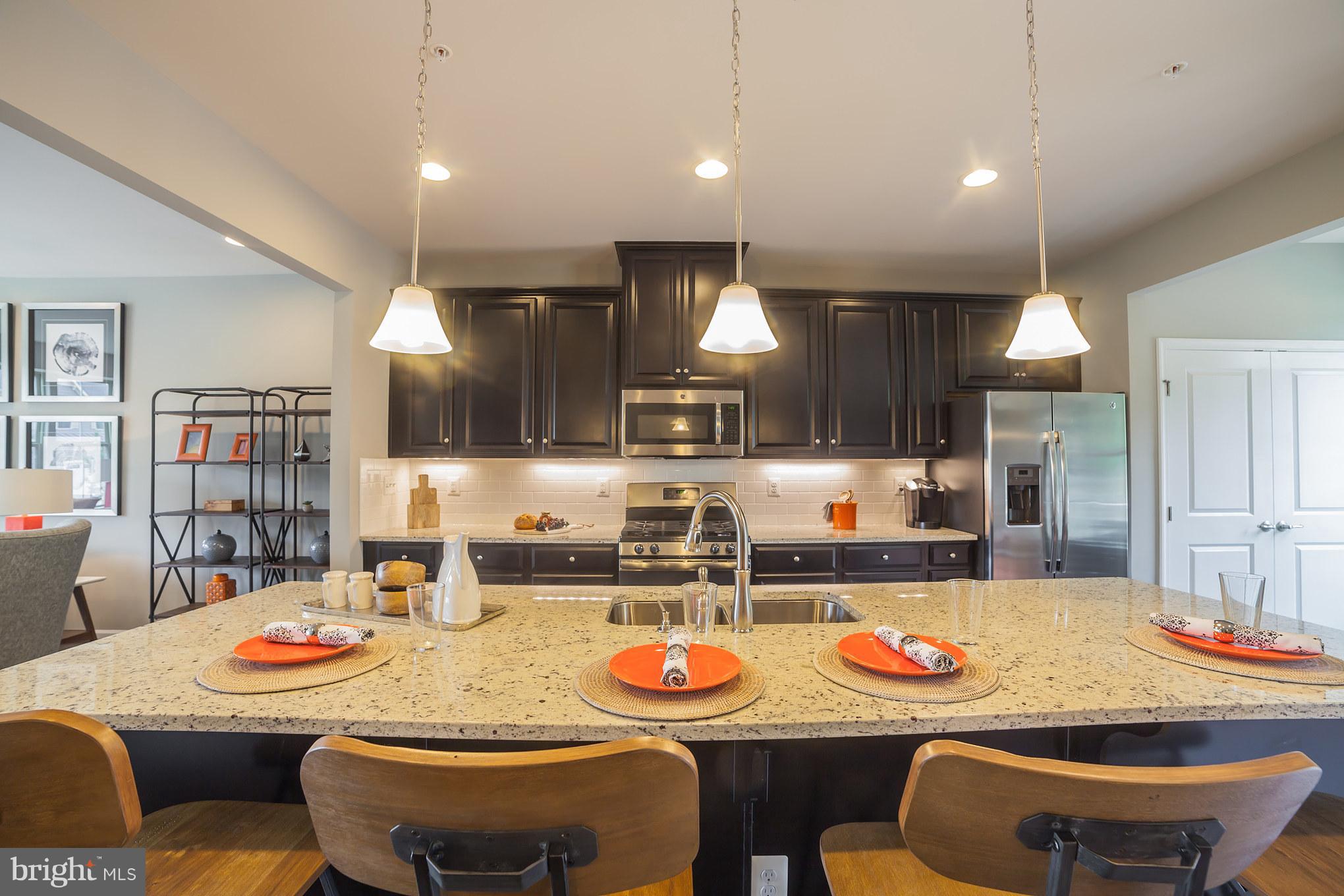 8283 Kippis Road Millersville, MD 21108 - Photo 4 of 28 a dining room with stainless steel appliances kitchen island a table and chairs