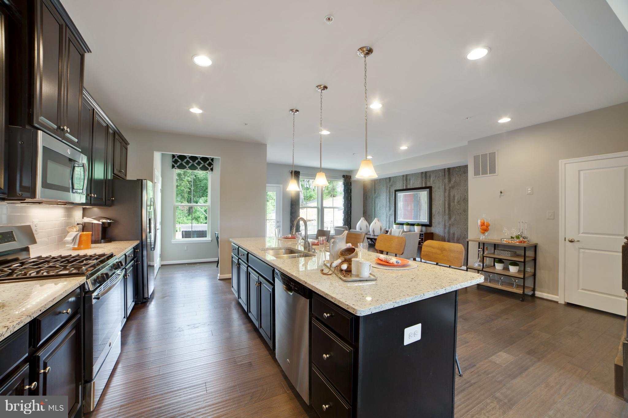 8283 Kippis Road Millersville, MD 21108 - Photo 6 of 28 a kitchen with a counter top space a sink stainless steel appliances and cabinets