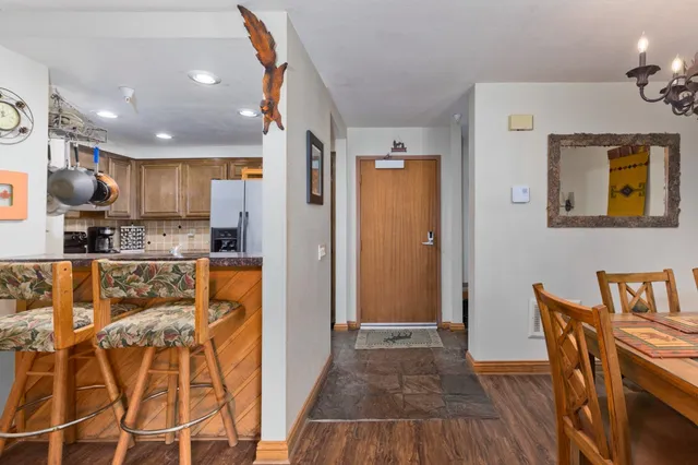 a kitchen with stainless steel appliances granite countertop a refrigerator and a stove top oven