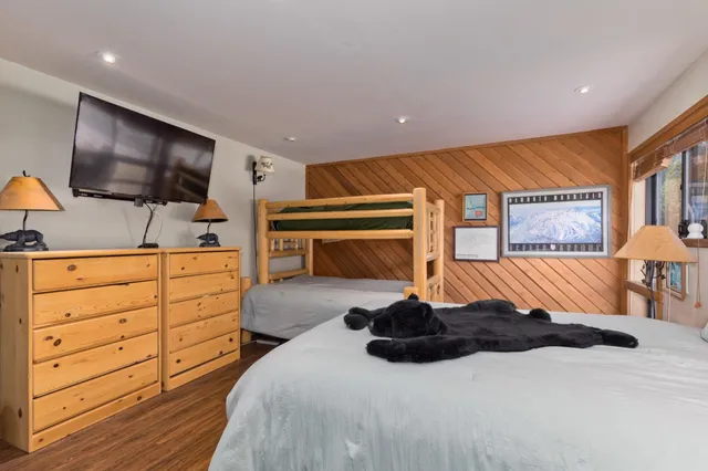 a bedroom with a bed and flat screen tv