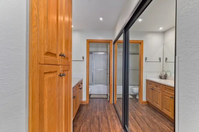 a bathroom with a glass door shower a sink and a mirror