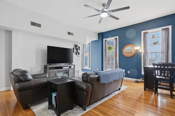 a living room with furniture and a flat screen tv