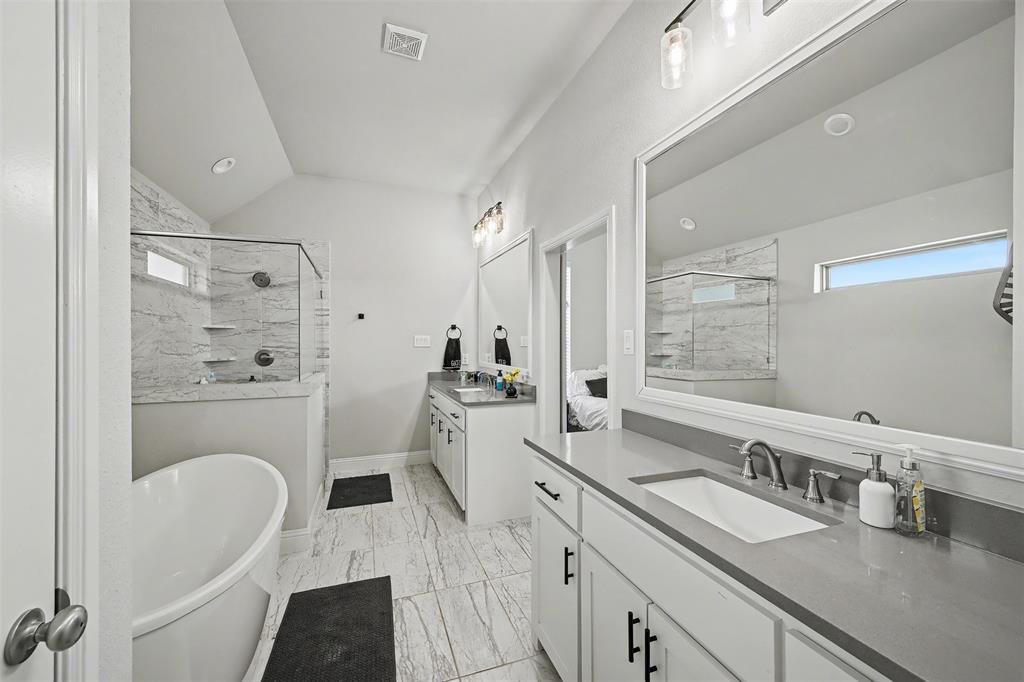 6334 Rustic Edge Street Godley, TX 76044 - Photo 15 of 26 a en suite bathroom with a granite countertop sink mirror and shower