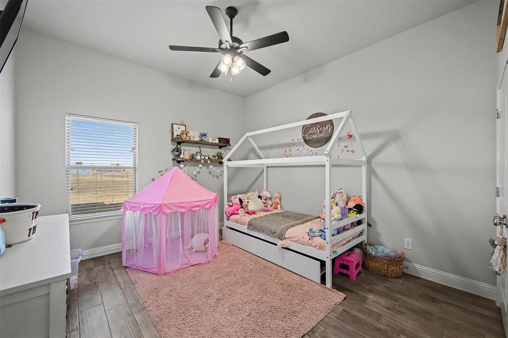 6334 Rustic Edge Street Godley, TX 76044 - Photo 16 of 26 a bedroom with furniture and a bed