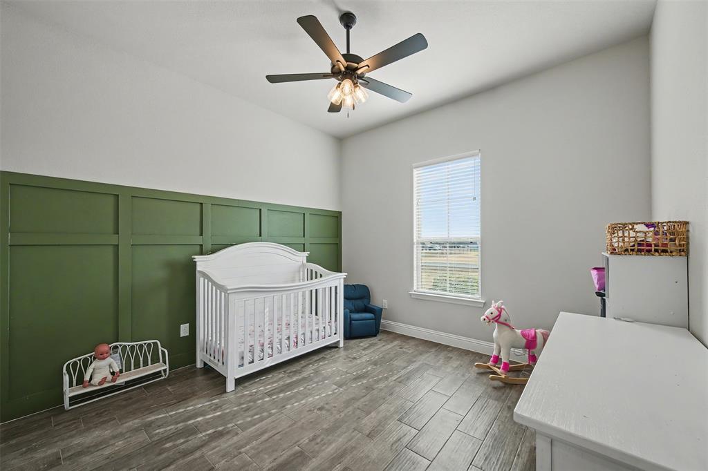 6334 Rustic Edge Street Godley, TX 76044 - Photo 18 of 26 a bedroom with a bed window and a window