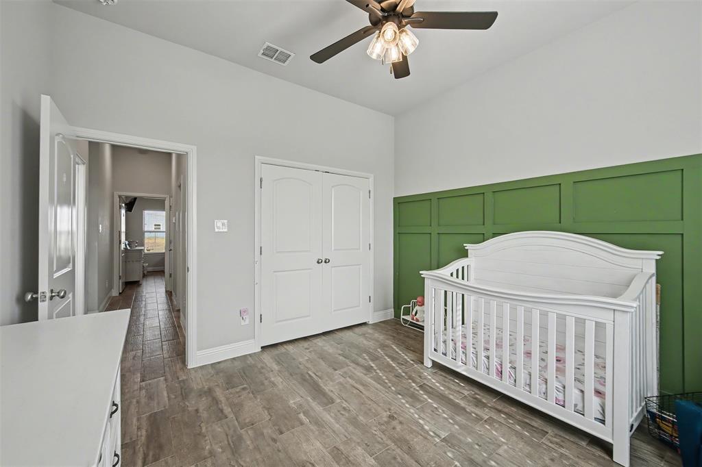 6334 Rustic Edge Street Godley, TX 76044 - Photo 19 of 26 a view of a room with wooden floor fan and windows