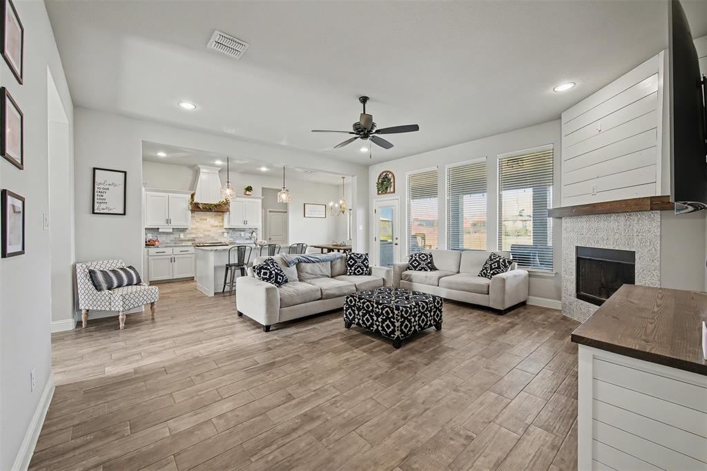 6334 Rustic Edge Street Godley, TX 76044 - Photo 7 of 26 a living room with furniture fireplace and a large window